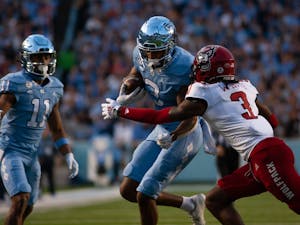 UNC senior wide receiver, Antoine Green (3), drives the ball downfield in Kenan Stadium on Nov. 25, 2022, as the Tar Heels face off against the NC State Wolfpack.