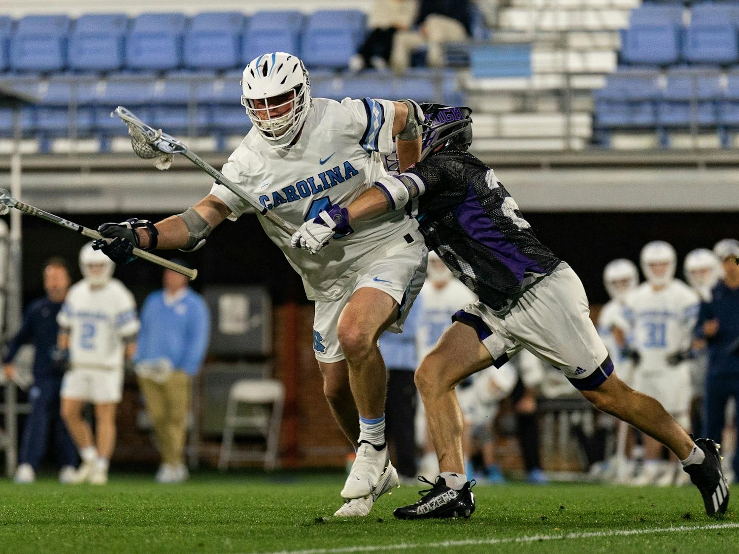 UNC graduate midfielder Harry Wellford (4) catches the ball during the men's lacrosse game against High Point on Wednesday, March 22, 2023, at Dorrance Field. UNC beat High Point 16-9.