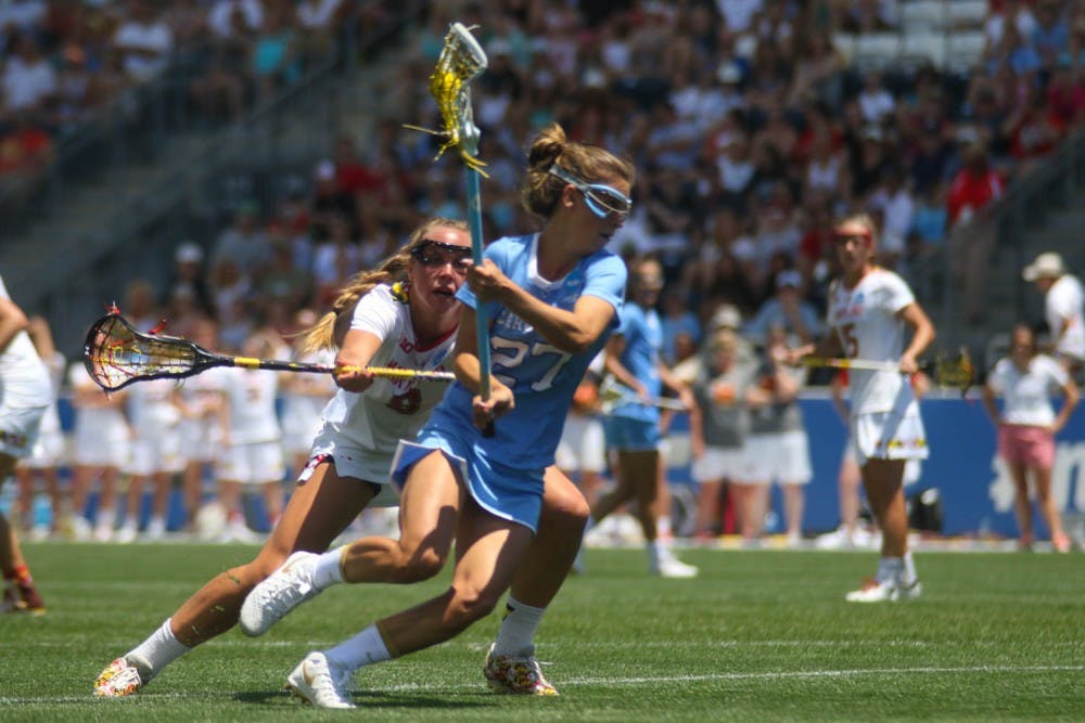 UNC attacker Aly Messinger (27) cradles the ball away from a Maryland defender. Messinger was named the NCAA Tournament's most outstanding player.&nbsp;The North Carolina women's lacrosse team defeated Maryland 13-7 to capture the NCAA championship on Sunday at Talen Energy Stadium in Chester, PA.
