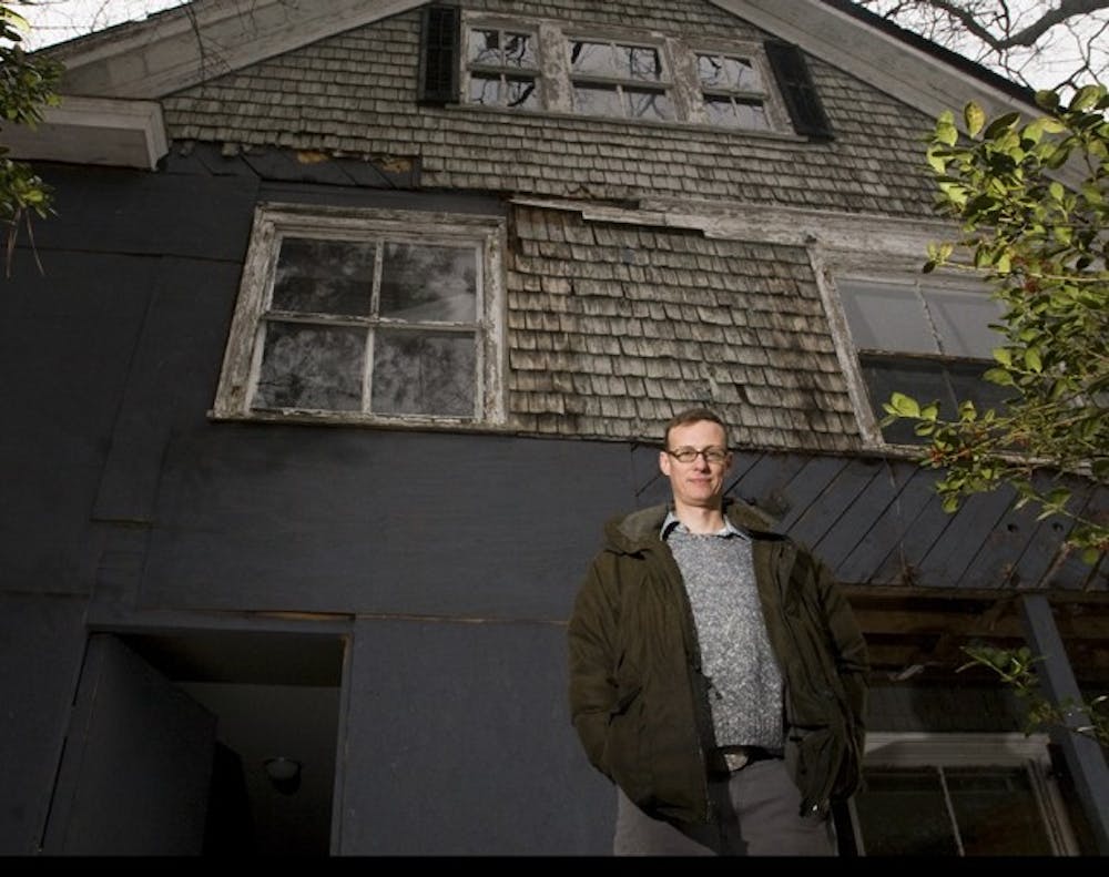 Earnest Dollar poses in front of the historic Edward Kidder Graham house in February.  Preservation North Carolina is trying to find a buyer.