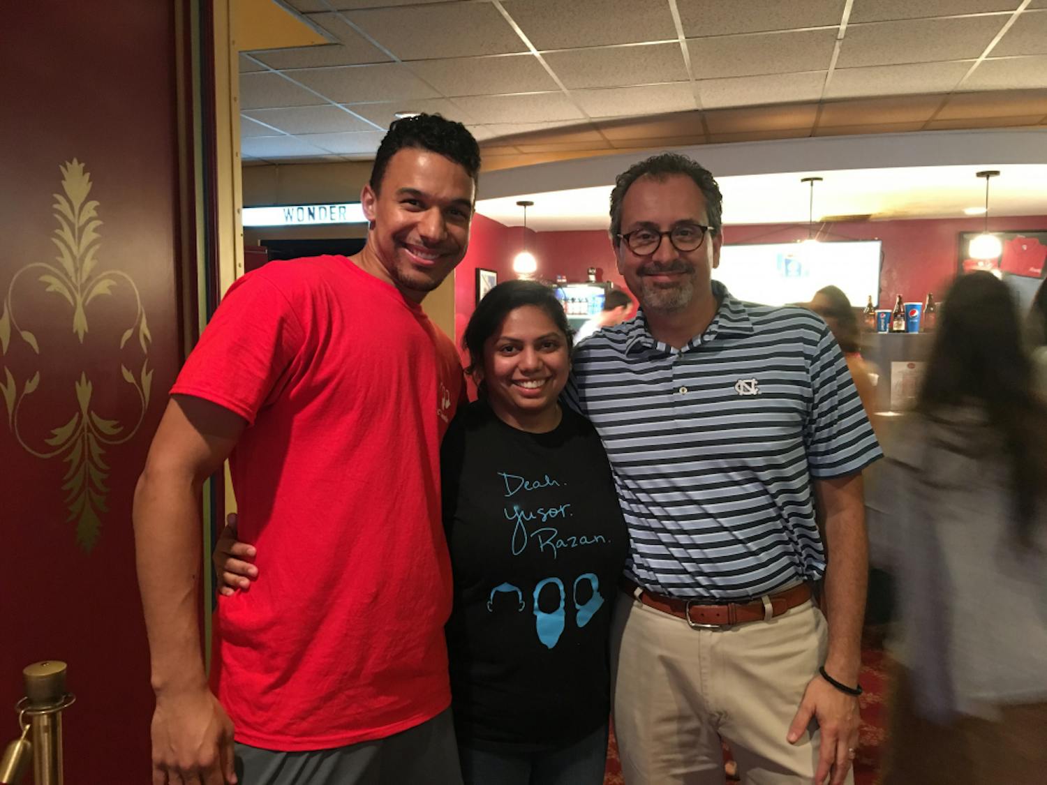 Jordan Sawyers, Kaushal Ghandi and School of Dentistry Dean Scott De Rossi pose at the Varisty Theatre at a talent show in honor of Yusor Mohammad Abu-Salha, &nbsp;Deah Shaddy Barakat and &nbsp;Razan Mohammad Abu-Salha.&nbsp;