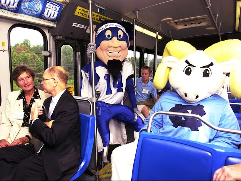 Former UNC Chancellor James Moeser rides with former Duke President
Nannerl Keohane on the Robertson Bus on its inaugural trip in 2001.

Courtesy of UNC News Services/Dan Sears