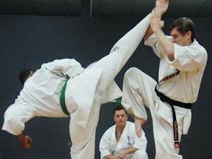 Instructor Nathan Ligo mentors Daniel Brandl and Donald Harris, two of five of his instructors for his Karate studio on Monday night. Donald Harris (left) is fighting in Japan next week. 