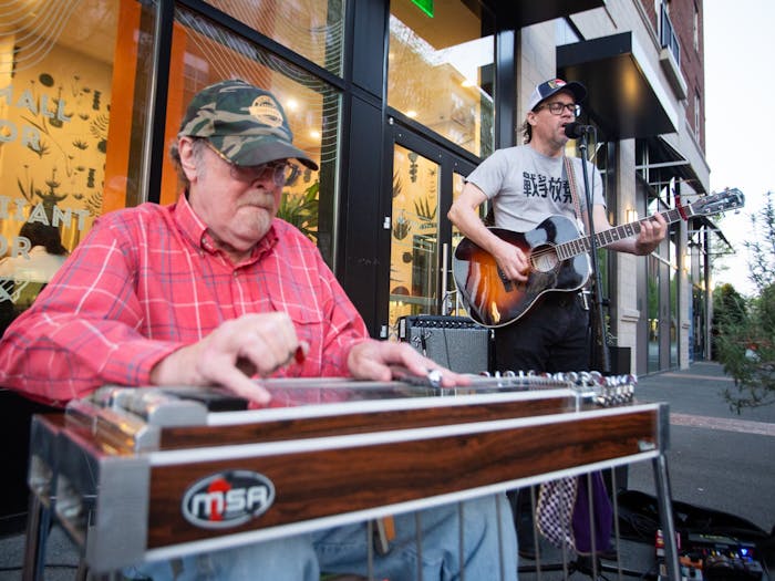 Musicians Clark Albert Blomquist and Steven Watson perform outside Roots Natural Kitchen on Franklin Street in Chapel Hill, North Carolina, on Saturday, April 1, 2023. The performance was part of the Downtown Live series, which features local musicians in outdoor settings in downtown Chapel Hill.