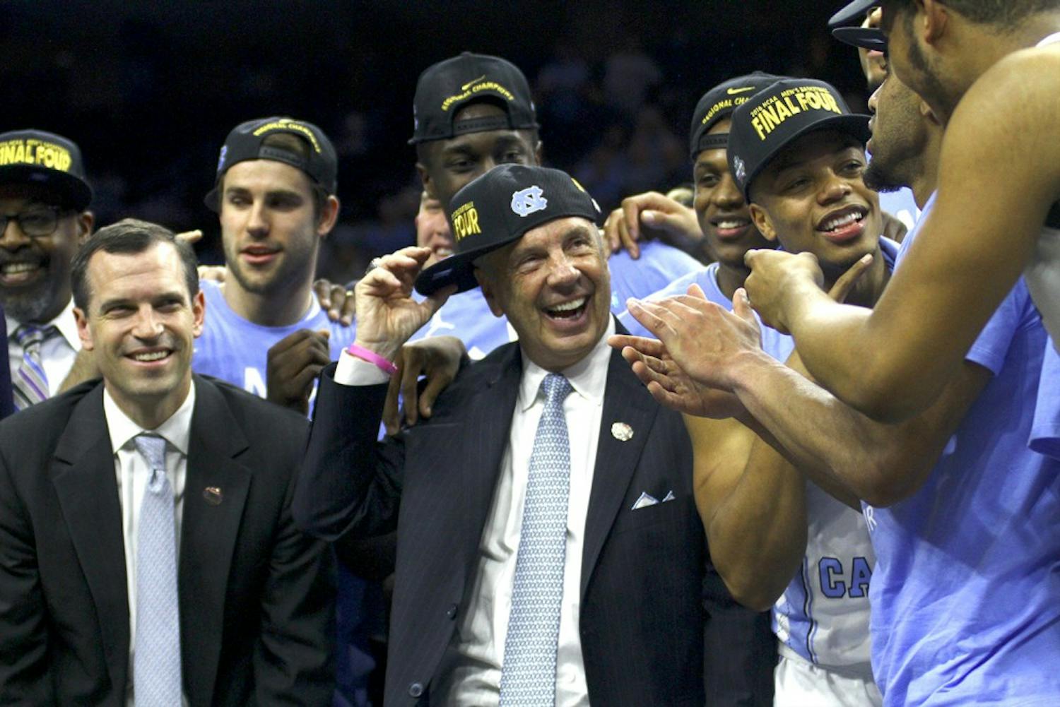 North Carolina men's basketball head coach Roy Williams celebrates with his team after winning a spot in the Final Four.&nbsp;