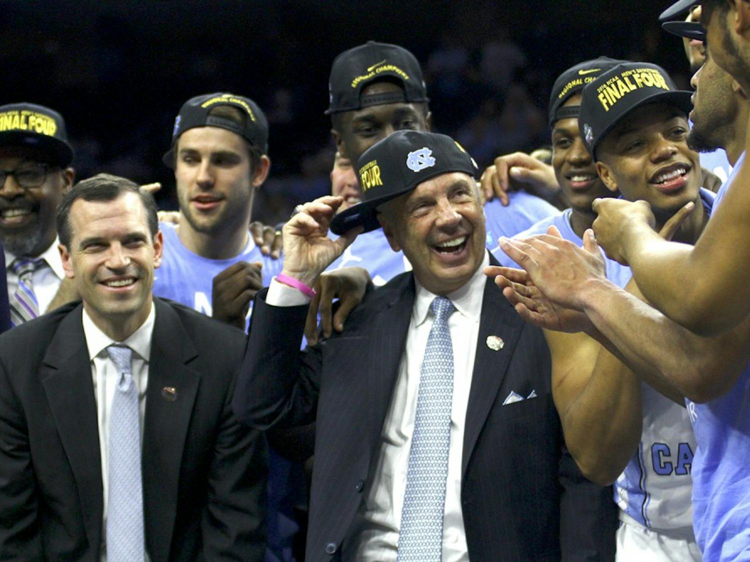 North Carolina men's basketball head coach Roy Williams celebrates with his team after winning a spot in the Final Four.&nbsp;
