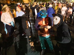 Three revelers gather on Franklin Street to perform a rap-off during the annual Halloween on Franklin event on the night of Thursday, Oct. 31, 2019. 
