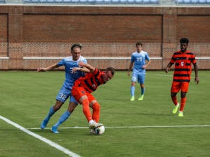 UNC midfielder Milo Garvanian (32) fights Syracuse midfielder Brian Hawkins (20) for the ball during a game at Dorrance Field on Saturday, Oct. 12, 2019. The Tar Heels lost 3-4.
