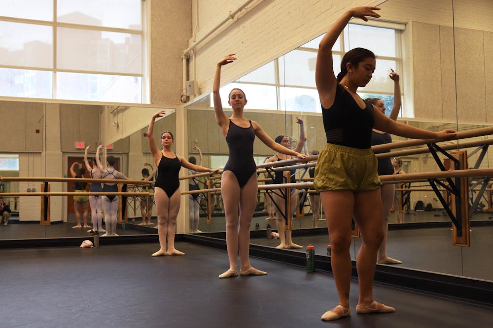 Sophomore Natalie Spencer, Junior Meredith Zinger, and Senior Kendra Tse warm up for a UNC dance class in the soon to be demolished Woollen B019 dance studio on Jan 17, 2023