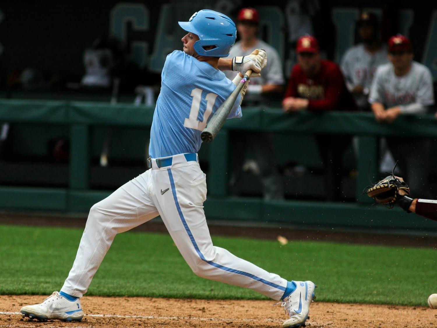 UNC first-year outfielder Reece Holbrook (11) offers at a pitch during the game against Elon on Tuesday, Feb. 22, 2022, at Boshamer Stadium. UNC won 5-1.