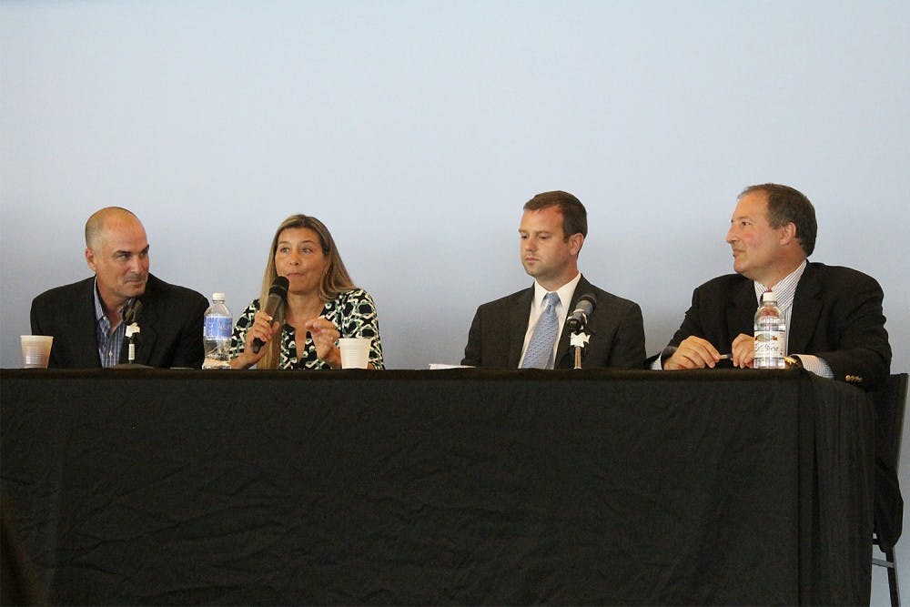 (From left to right) A panel including Jay Bilas, Barbara Osborne, Paul Pogge and Kenneth Hammer met on Wednesday evening in the Blue Zone in Kenan Stadium to discuss the recent O'Bannon v. NCAA court decision.