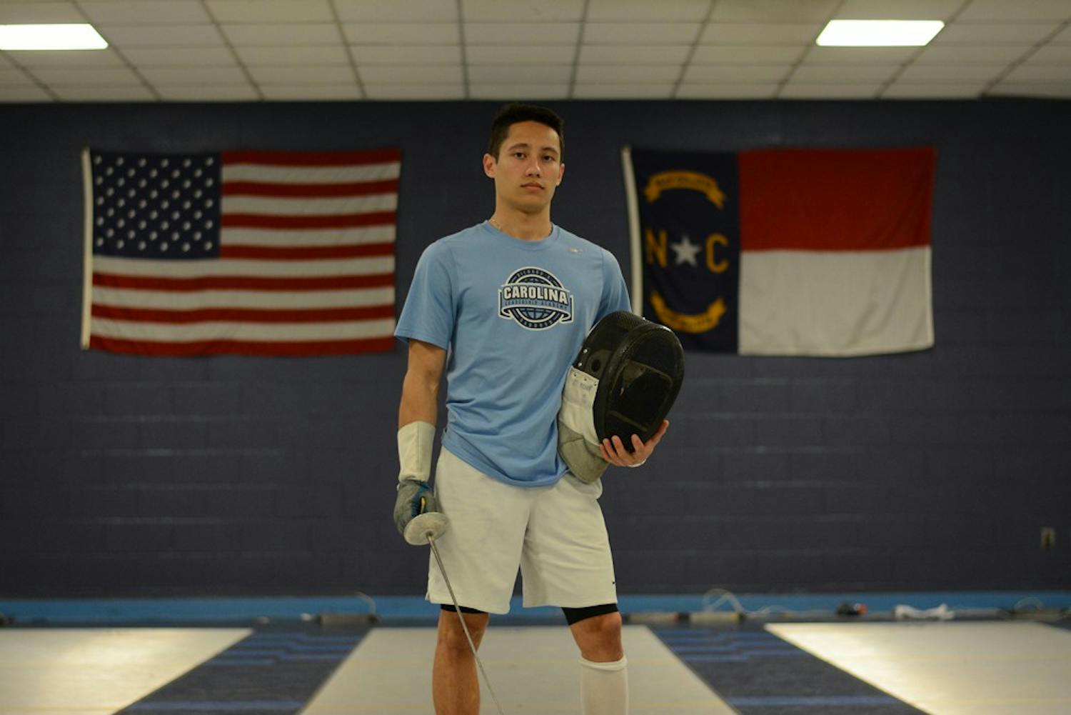 Ezra Baeli-Wang poses with his gear in the fencing room in 2017. The former UNC and ACC Student-Athlete Advisory Committee President wrote an open letter to University officials against Silent Sam that has been signed by almost 300 current and former UNC student-athletes.