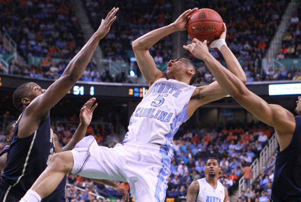 Marcus Paige is fouled hard. UNC lost to Pittsburgh 80-75 in the ACC Tournament at the Greensboro Coliseum.