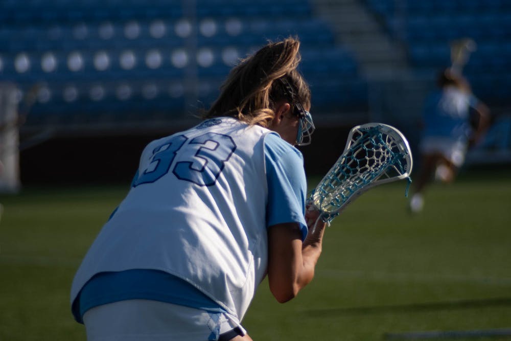UNC junior midfielder Sophie Student (33) stays focused in the women’s lacrosse game in Dorrance Field against High Point University on Thursday, March 23, 2023. (score)