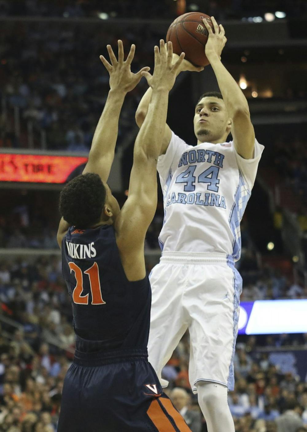 North Carolina wing Justin Jackson (44) pulls up over Virginia forward&nbsp;Isaiah Wilkins (21) in the ACC Tournament final on March 12. The Tar Heels play the Cavaliers on Saturday&nbsp;for the first time since this game.