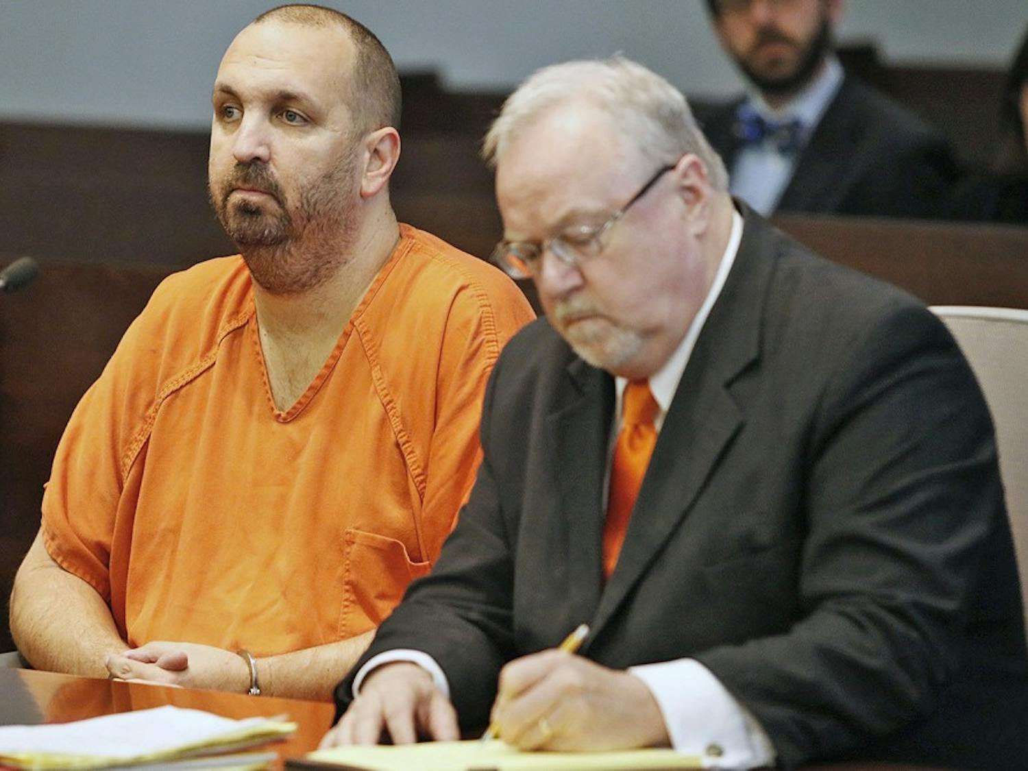 Murder defendant Craig Stephen Hicks, 46, left, listens while his co-defense counsel Terry Alford makes notes during a Monday, April 6, 2015 death penalty hearing for Hicks in Durham, N.C. Presiding Judge Orlando Hudson found the shooting deaths of three Muslim college students at Finley Forest residential complex in Chapel Hill in February 2015 made the Hicks case eligible for the death penalty. (Harry Lynch/Raleigh News &amp; Observer/TNS) 