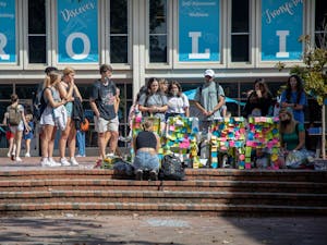 Content warning: This text contains mention of suicide.
Students add notes and flowers to the memorial in the Pit on Oct. 14, 2021. The memorial commemorates students who died by suicide during the fall 2021 semester.