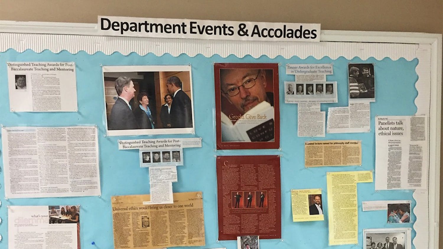 Jan Boxill is featured with Chancellor Folt and President Obama on a bulletin board in Caldwell Hall celebrating philosophy professors’ work.