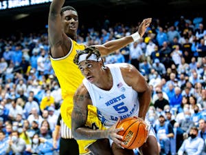 Forward Armando Bacot (5) prepares to shoot a layup at the game against Michigan on Dec. 1 at the Dean E. Smith Center. UNC beat Michigan 72-51.
