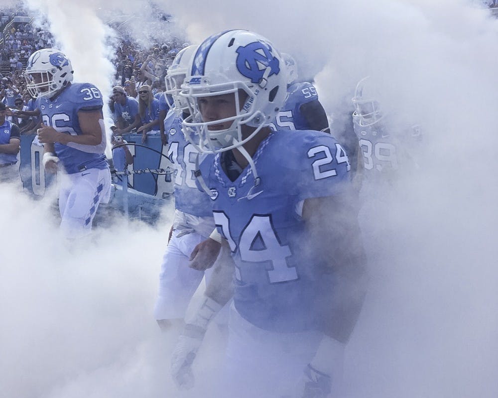 North Carolina defensive back Zach Goins (24) prepares to run out of the smoke filled tunnel. Photo Courtesy of Zach Goins.