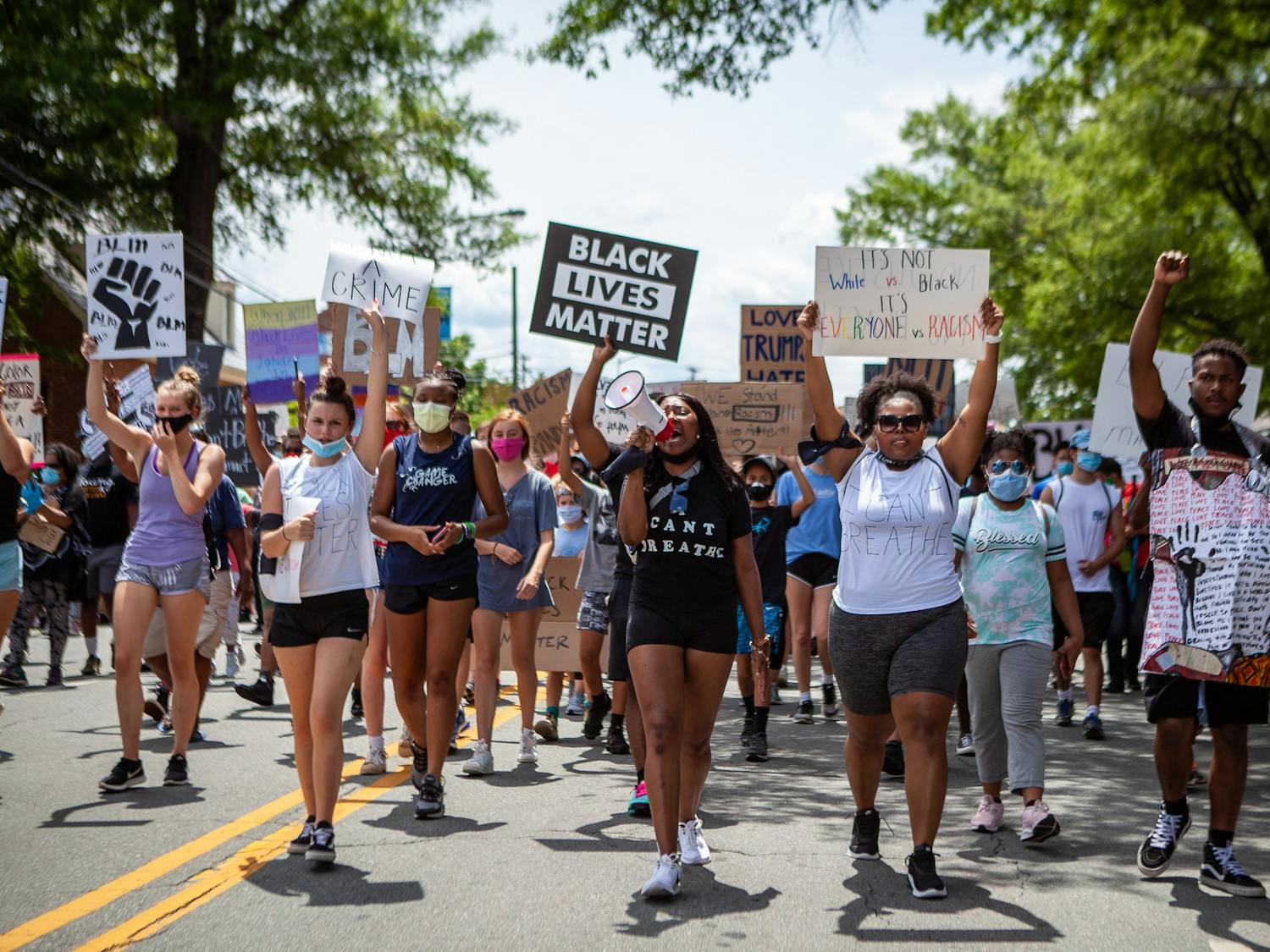 Niya Fearrington (left) and Victoria Fornville (right) lead the crowd at the Chapel Hill Rally for Justice in June. Photo courtesy of Dakota Moyer at Chapelboro.com.