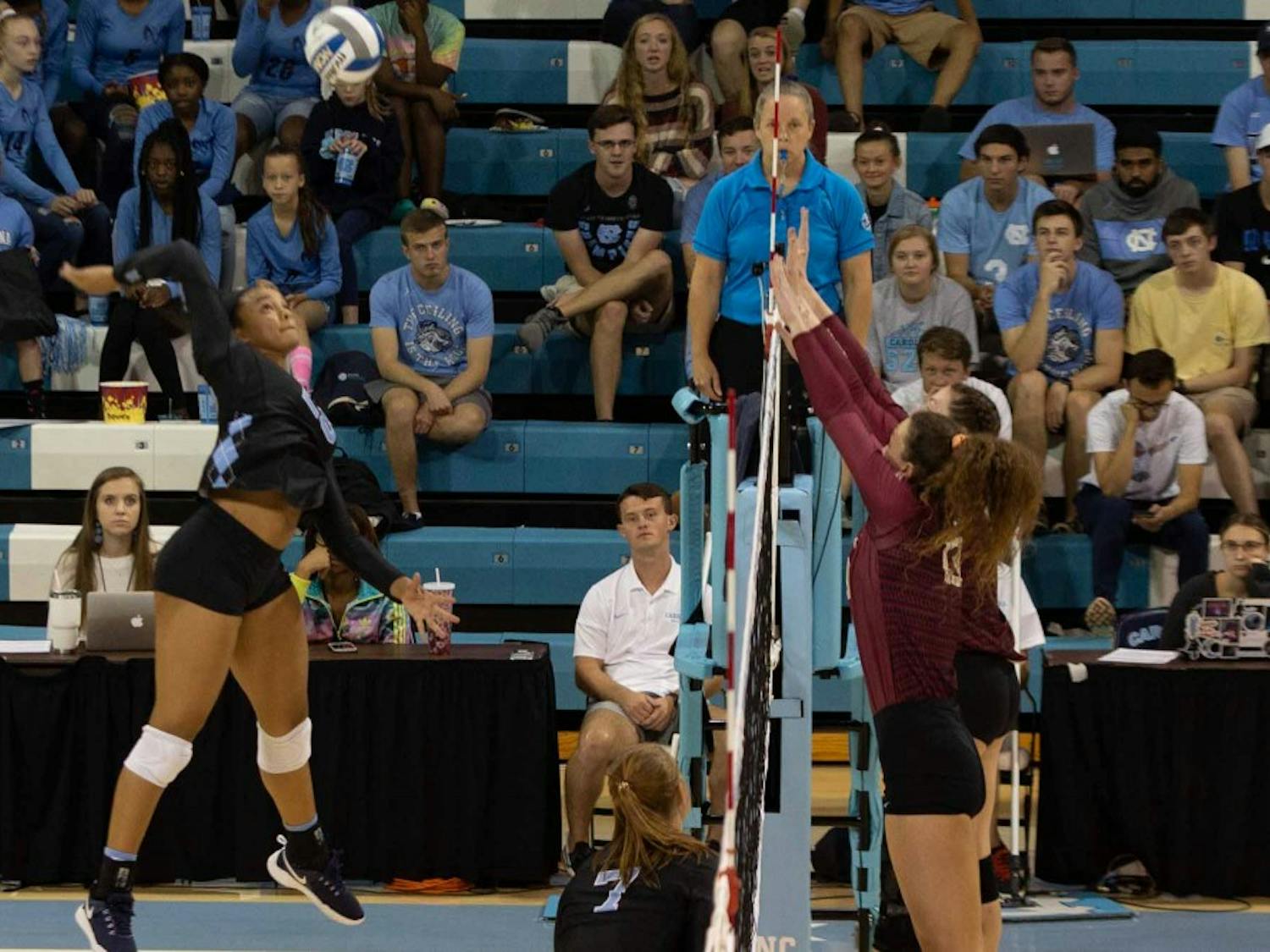 Redshirt first-year outside hitter Lauren Harrison (25) spikes the ball against two players from FSU. UNC won against FSU 3-2 at Carmichael Arena on Sunday, Oct. 13, 2019.