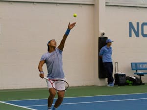 First-year tennis player Rinky Hijikata prepares to serve the ball against Vazha Shubladze and Diego Padilha of Georgia State during men's doubles in the Cone-Kenfield Tennis Center on Sunday, Jan. 26, 2020. Hijikata made his debut on Saturday, Jan. 25, 2020.
