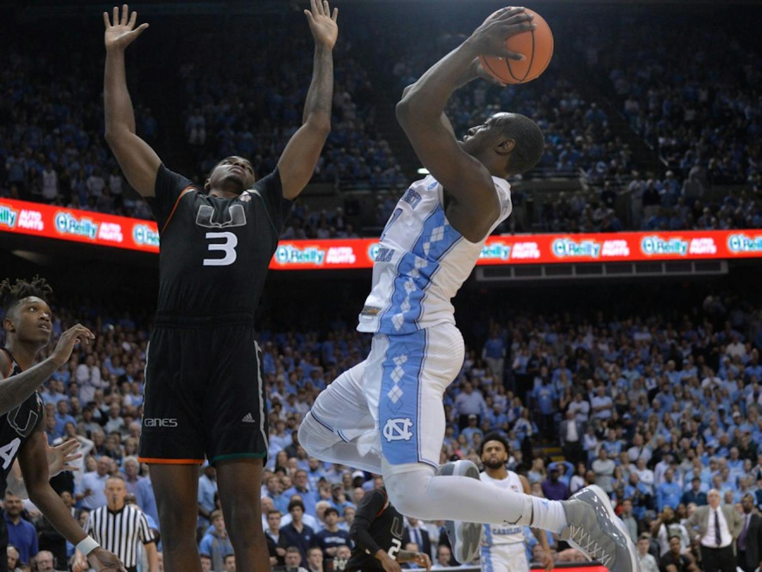 Senior forward Theo Pinson (1) rises up for a shot against Miami on Feb. 27 at the Smith Center.