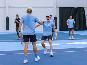 UNC graduate Ryan Seggerman and first-year Will Jansen celebrate at the Cone-Kenfield Tennis Center on Sunday, January 29, 2023. UNC beat Harvard 4-1.