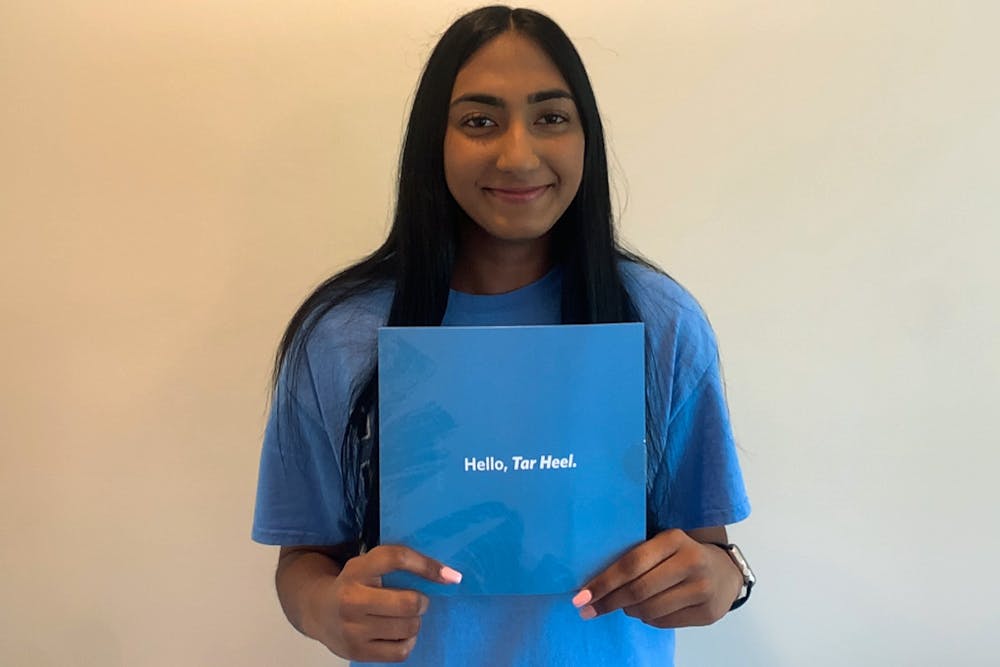 Nikita Umesh poses with her UNC acceptance letter for a virutal portrait in her home on Wednesday, May 26th, 2021. Umesh intends to major in Biology and is excited about the upcoming fall semester.