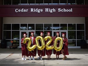 Cedar Ridge Class of 2020 graduates stand in front of Cedar Ridge High School on Friday, May 15, 2020. In lieu of an in-person graduation, the school has proposed a "drive-thru" graduation ceremony, a solution that many students are opposed to. Photo courtesy of Caitlyn Loyd and photographer Shili Quade
