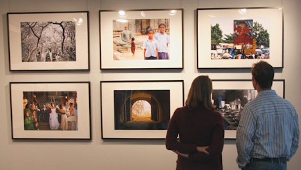 Visitors to the FedEx Global Education Center observe the winning photos. DTH/Colleen Cook