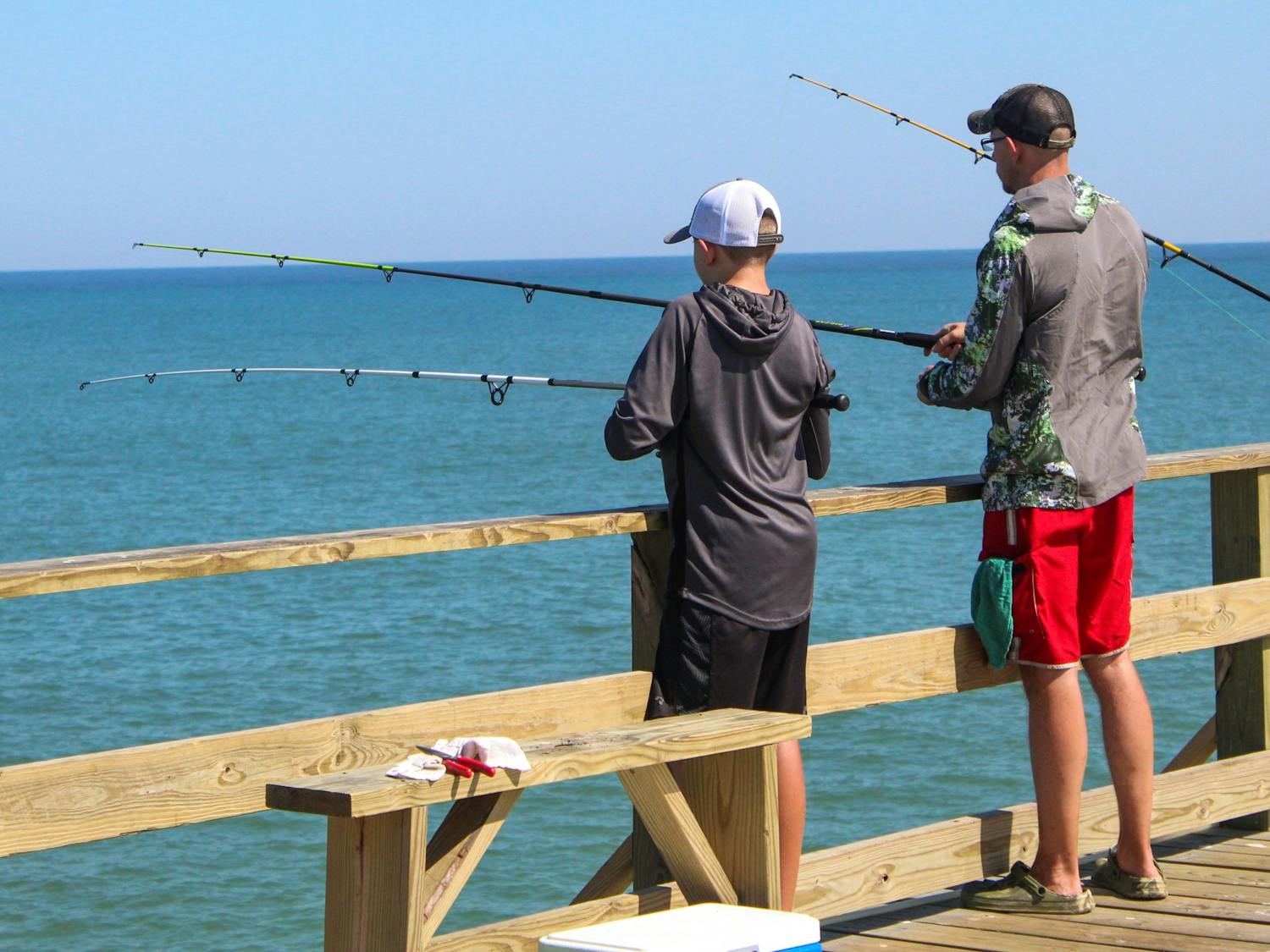 A pier at Kure Beach gathers many groups of family and friends who fish together during a late afternoon on Oct. 8, 2020.