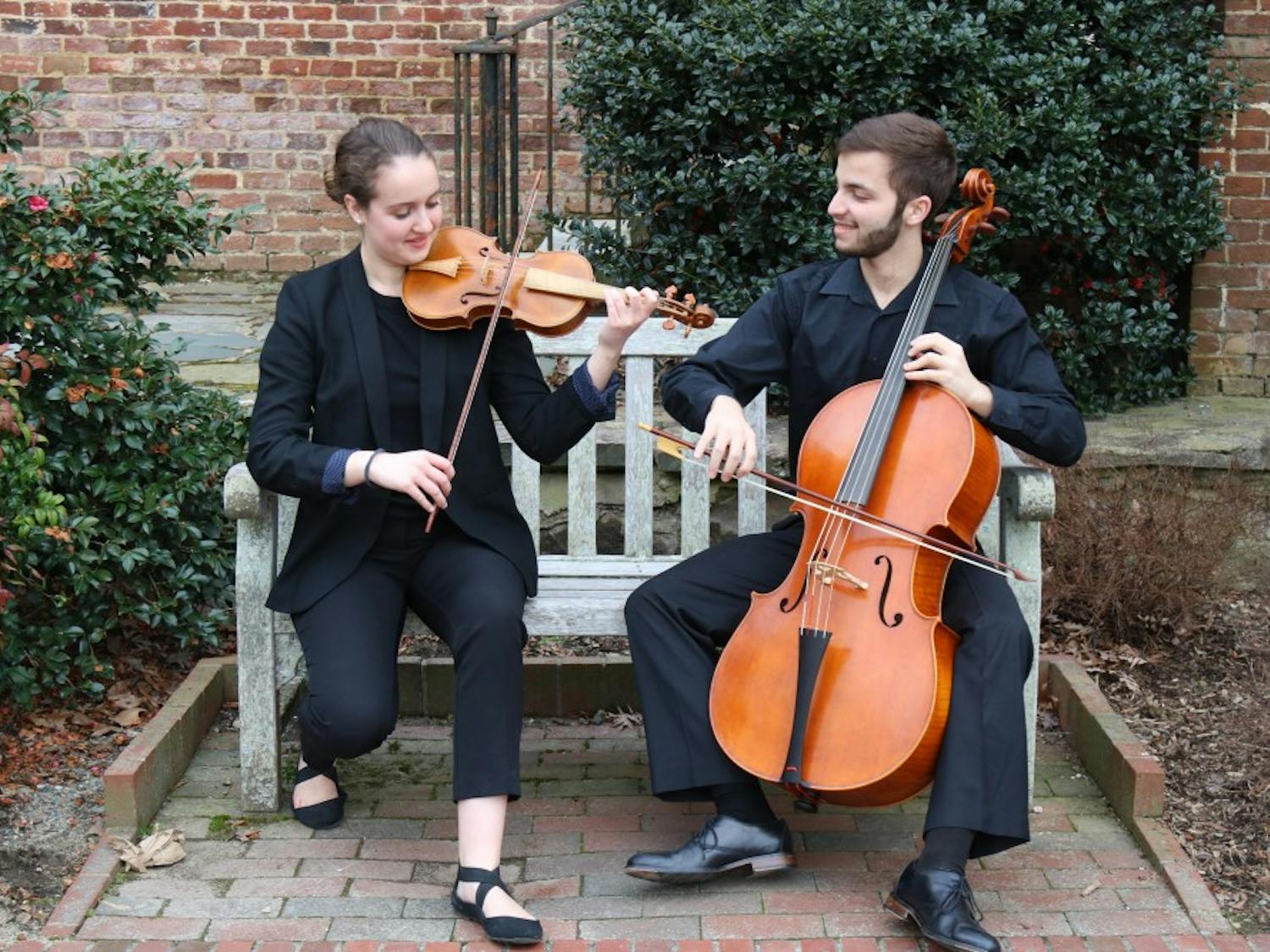 Emma Schubart (left), a sophomore music performance and political science major, and Daniel Malawsky (right), a junior biostatistics and mathematics major, play in front of Patterson Hall on Sunday, Feb. 3, 2019. Emma and Daniel are both part of the student orchestra of the opera at UNC. 