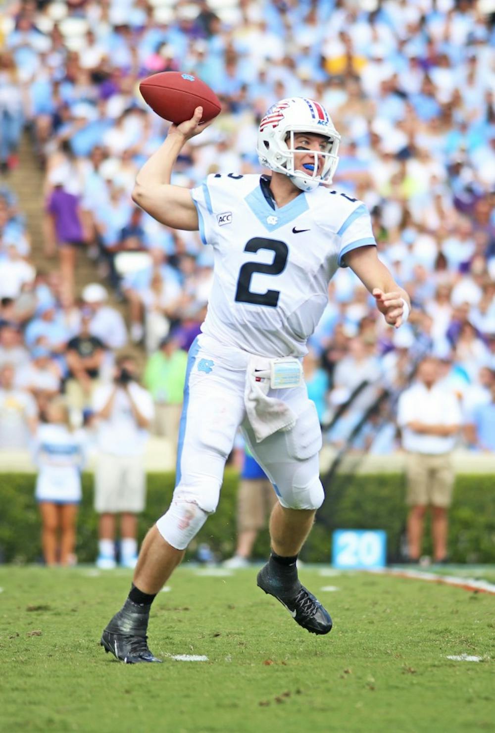 	UNC quarterback Bryn Renner (2) threw for a career high 366 yards, and also passed former UNC quarterback T.J. Yates.