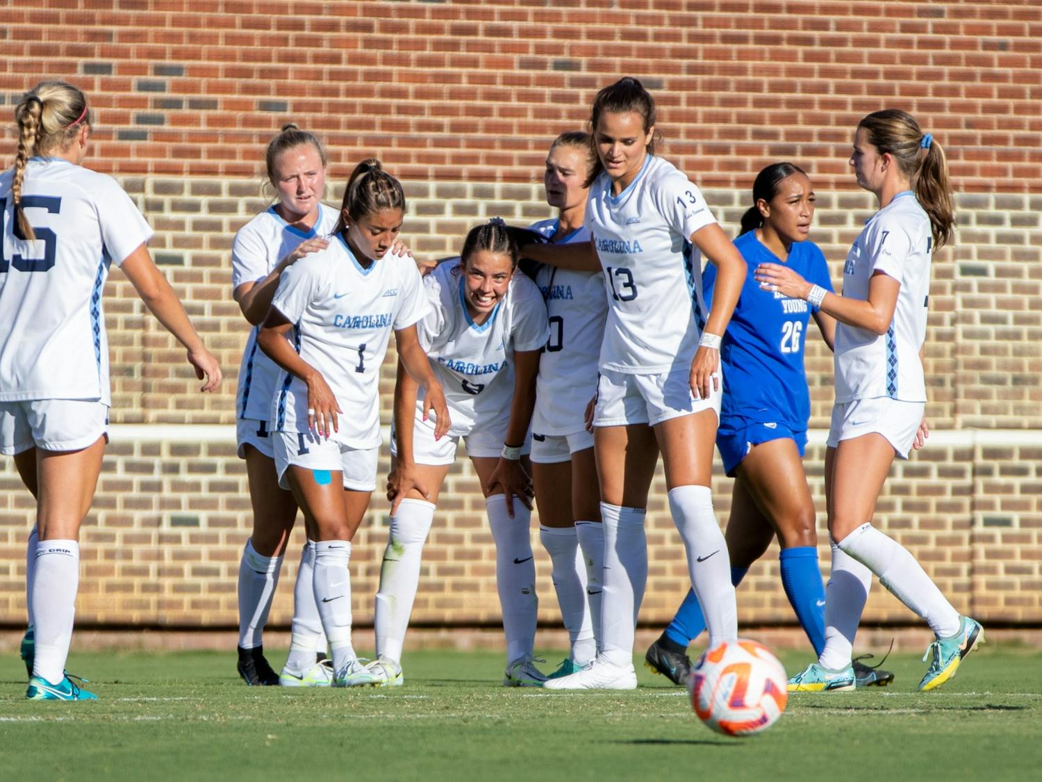 Freshman forward Tori Dellaperuta (9) is embraced by her teammates after scoring her second goal in as many games on Aug. 13, 2022. UNC beat BYU 2-0 at Dorrance Field in their second exhibition match of the season.