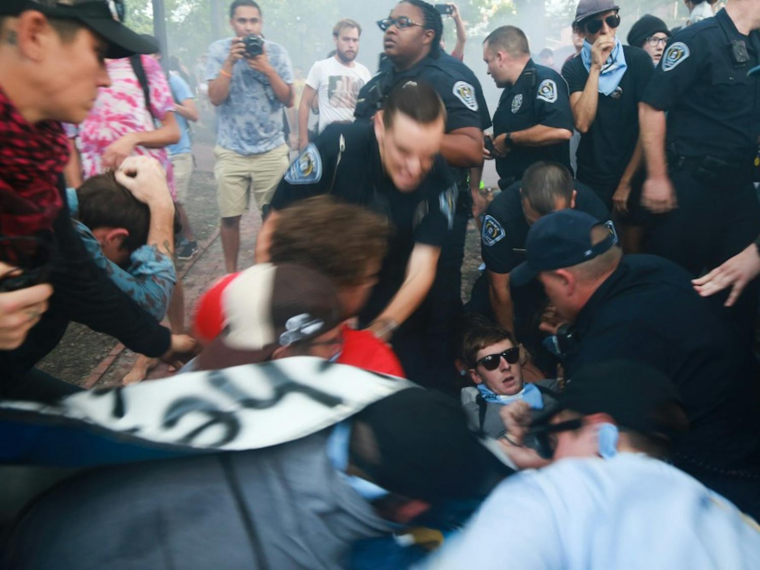 UNC Department of Public Safety officers hold down a protestor.