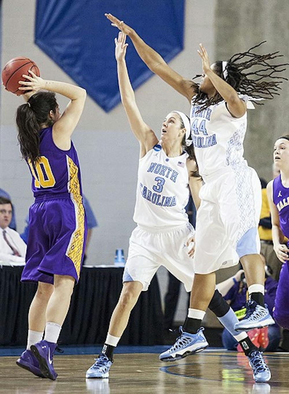UNC's Megan Buckland(3) and Tierra Ruffin-Pratt(44) defend against Albany's Lindsey Lowrie(10)