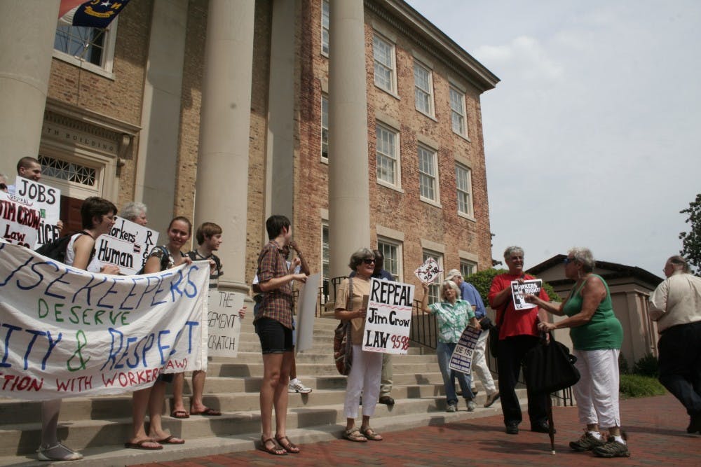Housekeepers and students, organized by Miriam Thompson (right), marched to South Building to deliver their grievances to Chancellor Holden Thorp.
