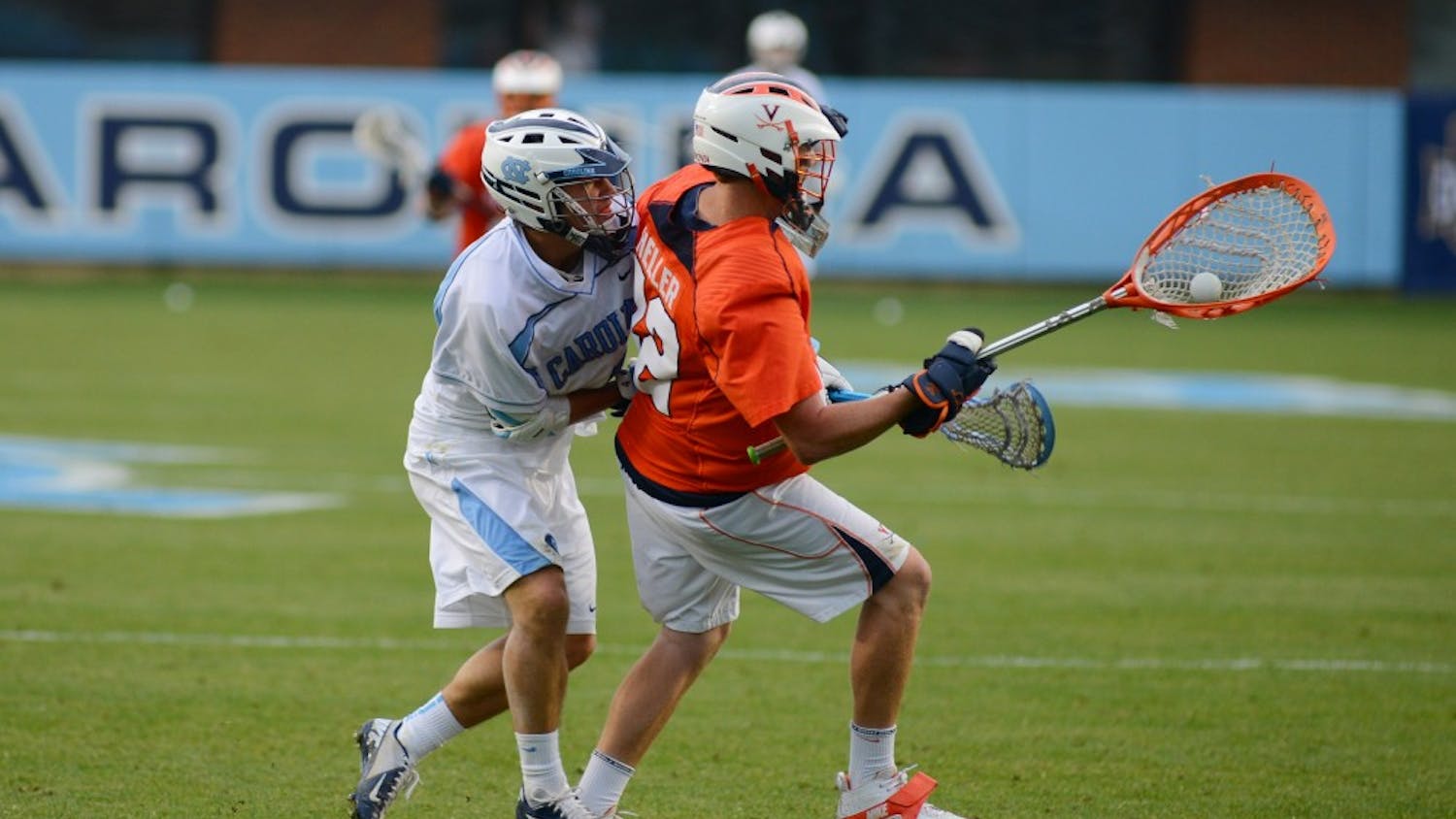 UNC attacker Jimmy Bitter (4) forces a turnover from Virginia goalkeeper Rhody Heller (42).