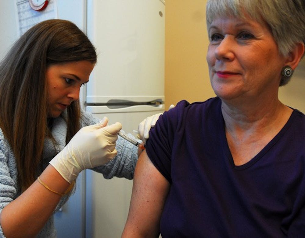 Clinical pharmacist Lisa Adams Padgett administers the H1N1 vaccine to Susan Winters at Kerr Drug. DTH File/Lauren Vied