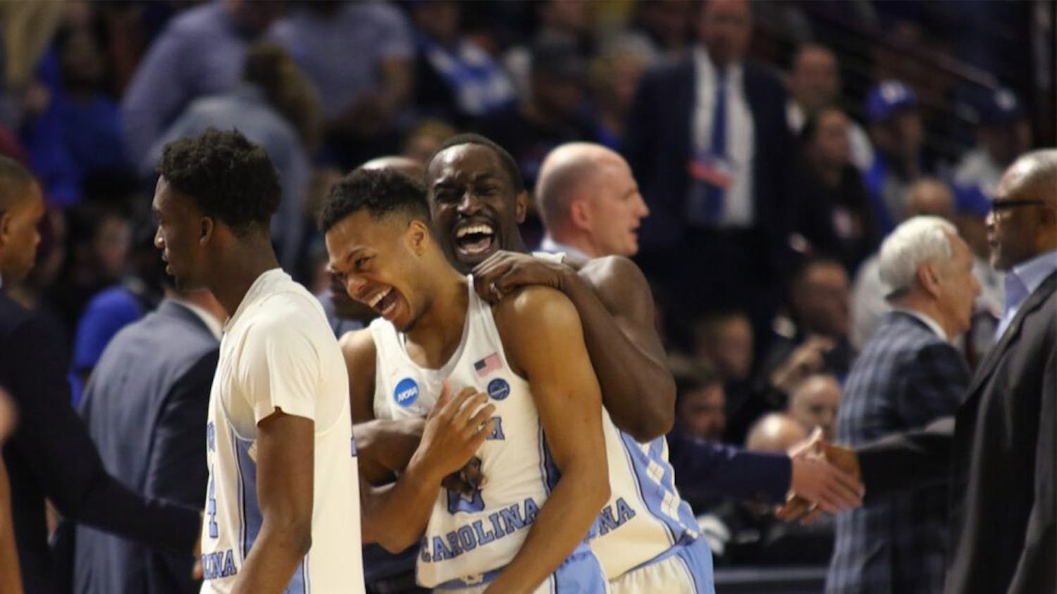 North Carolina wing Theo Pinson (1) and guard Nate Britt (0) celebrate after defeating Arkansas in the second round of the NCAA Tournament in Greenville on Sunday.&nbsp;Trailing 65-60 with 3:28 left, UNC closed the game on a 12-0 run to beat Arkansas.