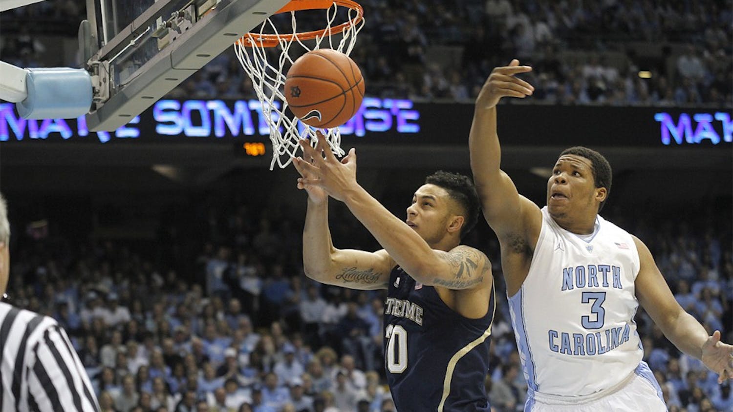 Freshman forward Kennedy Meeks (3) tries to rebound over a Notre Dame player. Carolina defeated Notre Dame 63-61 on Monday in the Dean Dome. 