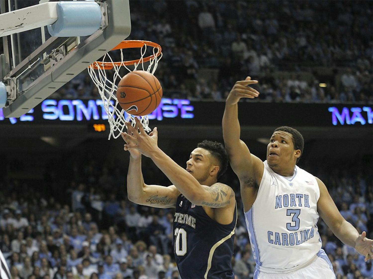 Freshman forward Kennedy Meeks (3) tries to rebound over a Notre Dame player. Carolina defeated Notre Dame 63-61 on Monday in the Dean Dome. 
