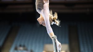 Junior Elizabeth Culton First-year competes on uneven bars during UNC gymnastics' home meet at Carmichael Arena on Friday, Jan. 28, 2022. Culton scored a 9.850, tying her for first on bars.
