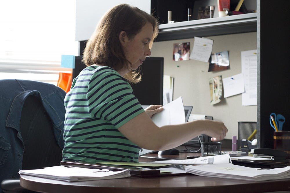 Professor Tori Ekstrand works in her office in Carroll Hall Monday afternoon. Ekstrand teaches in the School of Journalism and Mass Communications and gives her students warnings about sensitive topics in class. "It's not so much about triggers," Ekstrand said. "It's about helping students realize the realities we face and our responsibilities."