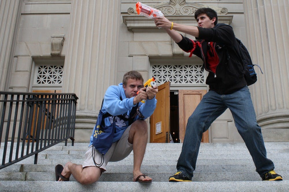 Freshmen Ethan Butler and Andrew Burchins, who were both humans as of Monday afternoon, participate in the campus-wide Humans v. Zombies game.
