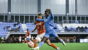UNC junior Ernest Bawa (20) keeps the ball away from a Clemson player in the men's soccer game against Clemson on Monday, Oct. 3, 2022, at Dorrance Field. Clemson topped UNC 1-0.