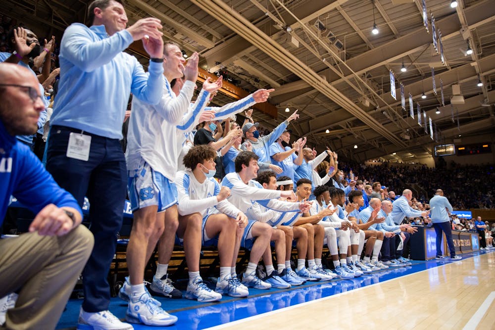 The UNC bench explodes at the game against Duke at Cameron Stadium on March 5, 2022. UNC won 94-81.