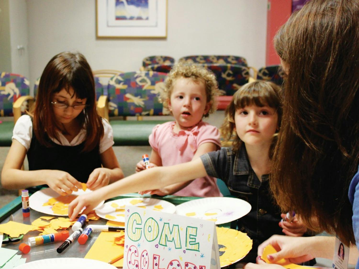 Sisters Dallas, April and Haily Ivey color and create paper jack-o-lanterns with ArtHeels at the UNC Children’s Hospital Tuesday afternoon. ArtHeels is a student volunteer organization that brings art and activities to pediatric and geriatric patients at UNC Hospitals.